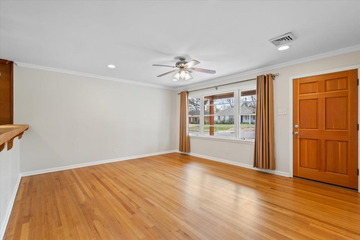 1556 Hayne Road Memphis, TN 38119 - Photo 6 of 27 a view of an empty room with a window and wooden floor