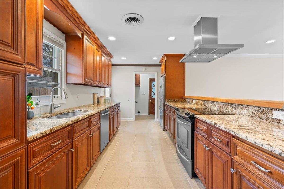 1556 Hayne Road Memphis, TN 38119 - Photo 10 of 27 a kitchen with stainless steel appliances granite countertop lots of counter top space a sink and cabinets