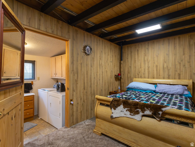5082 Pine Crest Road Evanston, UT 82930 - Photo 18 of 25 Room featuring natural wood paneling, exposed ceiling beams, and a light wood bed frame