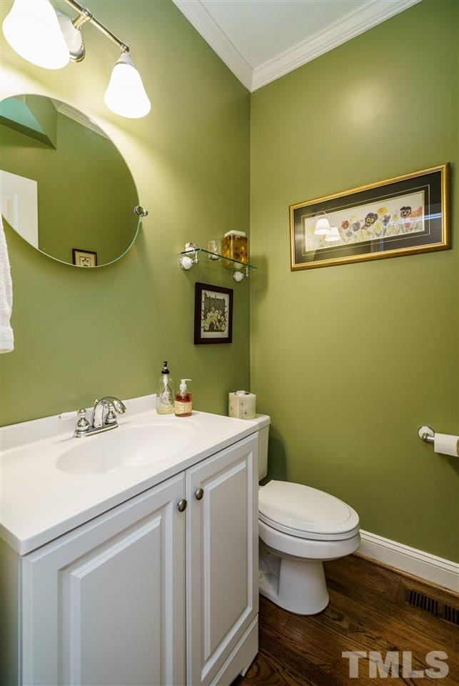 8119 Dreamy Way Raleigh, NC 27613 - Photo 16 of 30 a bathroom with a sink a toilet and mirror