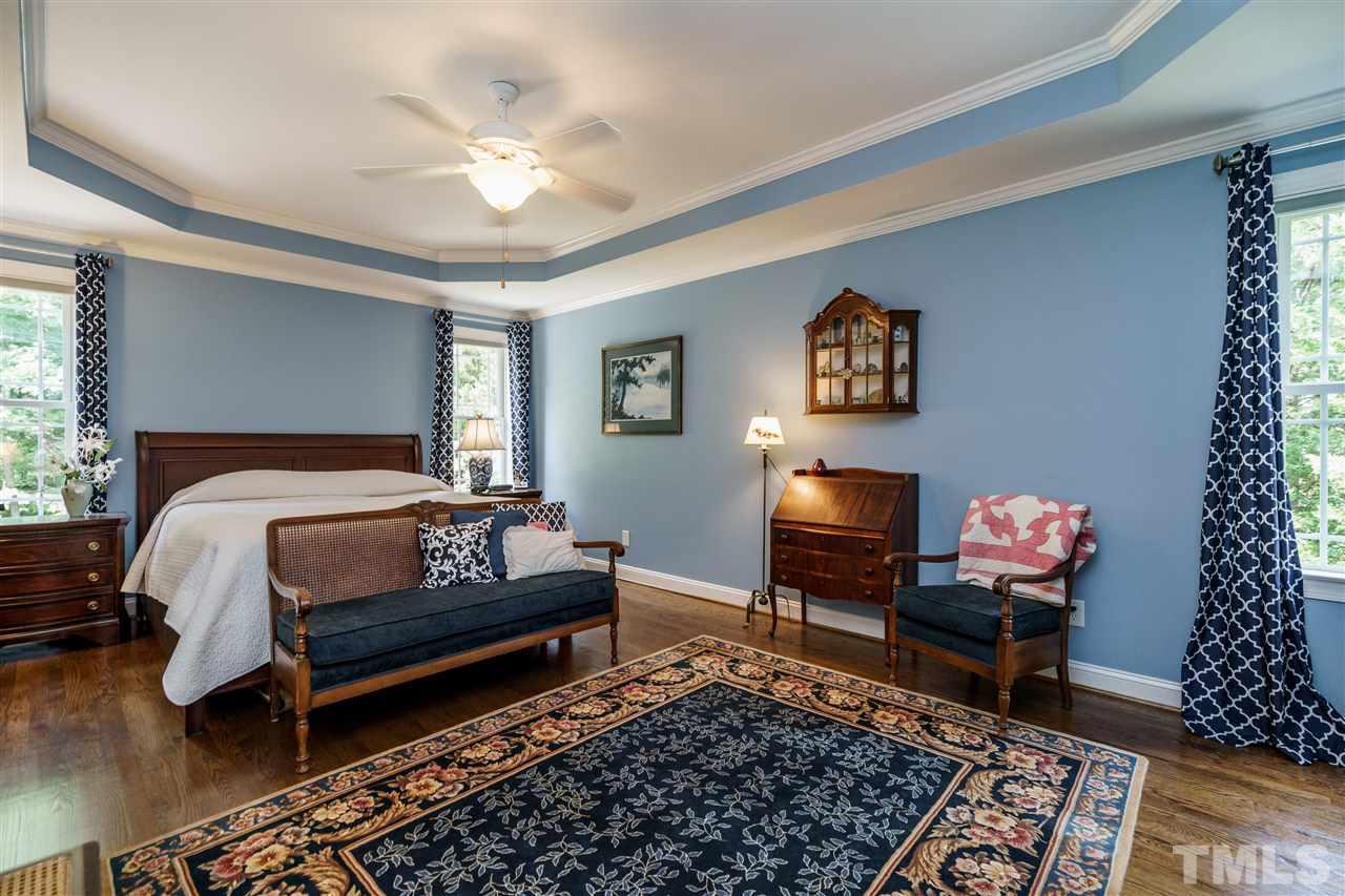 8119 Dreamy Way Raleigh, NC 27613 - Photo 17 of 30 a bedroom with a bed and wooden floor