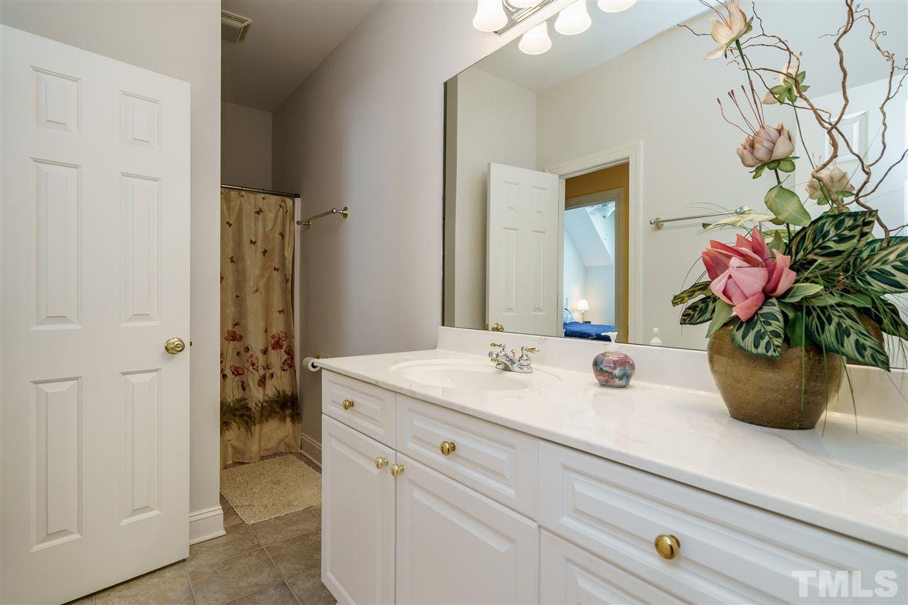 8119 Dreamy Way Raleigh, NC 27613 - Photo 22 of 30 a bathroom with a sink a vanity and a mirror