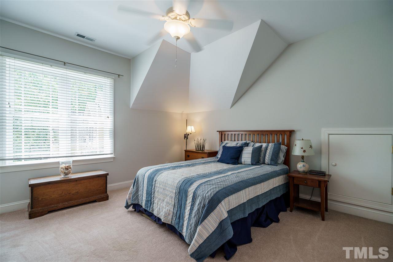 8119 Dreamy Way Raleigh, NC 27613 - Photo 24 of 30 a bedroom with a bed dresser and a window