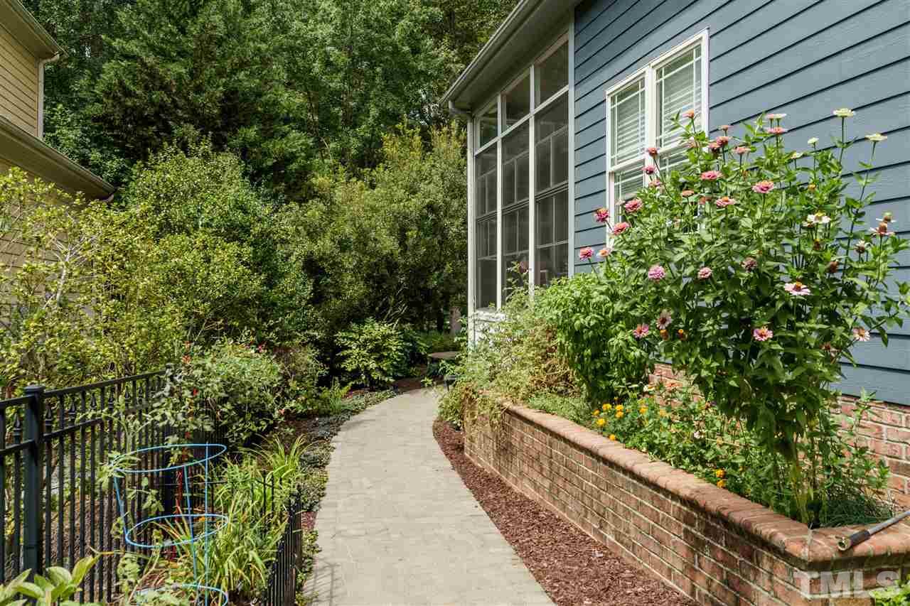 8119 Dreamy Way Raleigh, NC 27613 - Photo 28 of 30 a view of a house with a flower garden