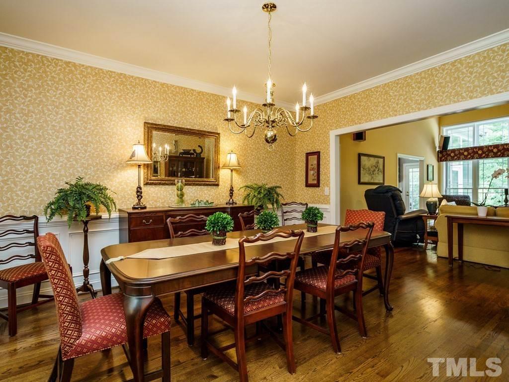 8119 Dreamy Way Raleigh, NC 27613 - Photo 4 of 30 a view of a dining room with furniture and wooden floor