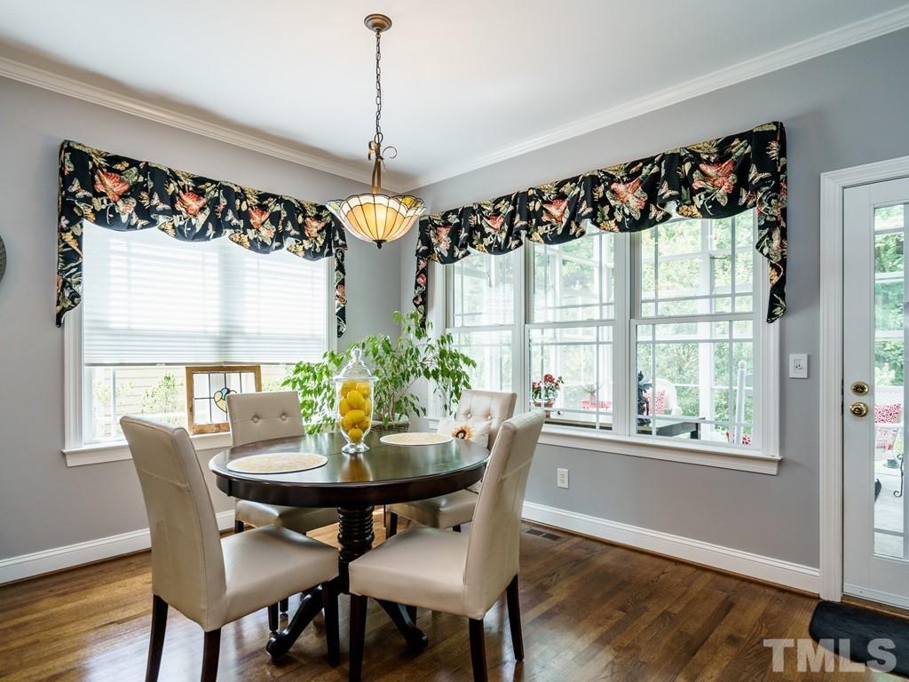 8119 Dreamy Way Raleigh, NC 27613 - Photo 10 of 30 a view of a dining room with furniture window and wooden floor