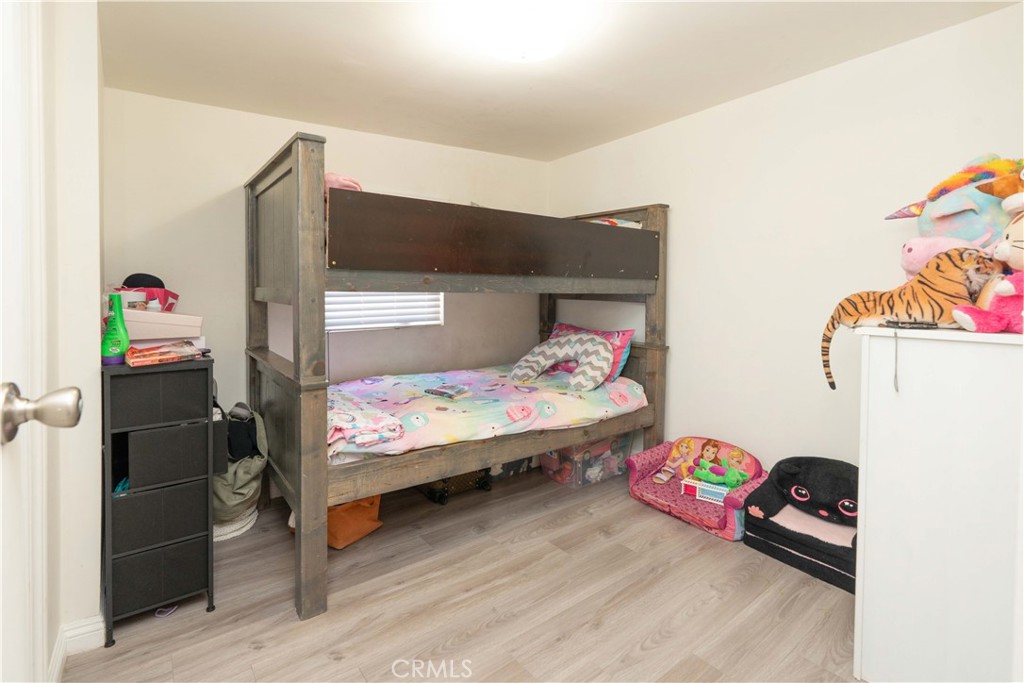 285 West 9th Street San Pedro, CA 90731 - Photo 20 of 22 a bedroom with bed and wooden floor