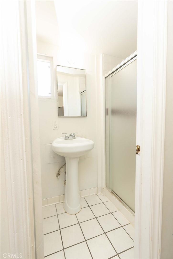 285 West 9th Street San Pedro, CA 90731 - Photo 22 of 22 a bathroom with a sink a toilet and mirror