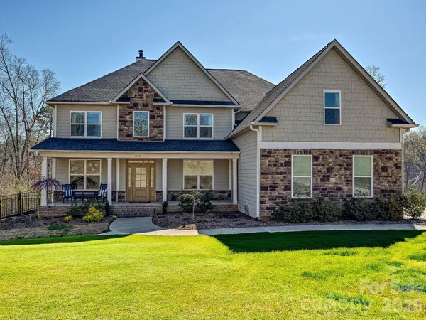 a front view of a house with swimming pool having outdoor seating