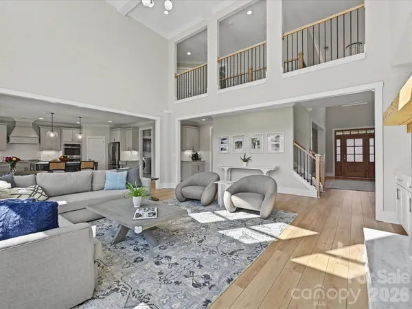 a view of a hallway with wooden floor and windows
