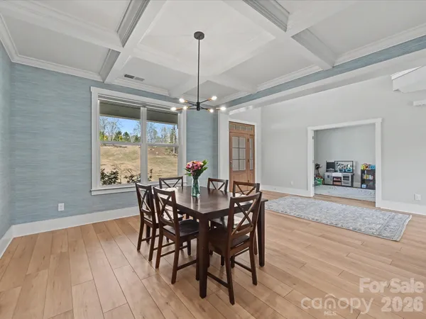 a spacious bedroom with a bed and a chandelier