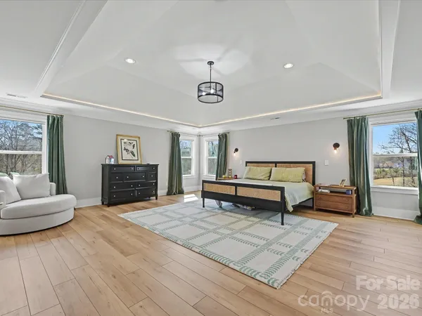 a en suite bathroom with a granite countertop sink and a mirror