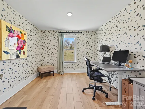 a view of swimming pool with outdoor seating and trees in the background
