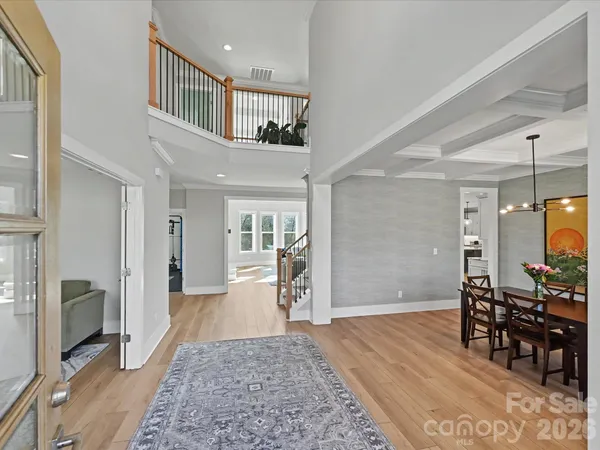 a kitchen with a sink stove and wooden floor