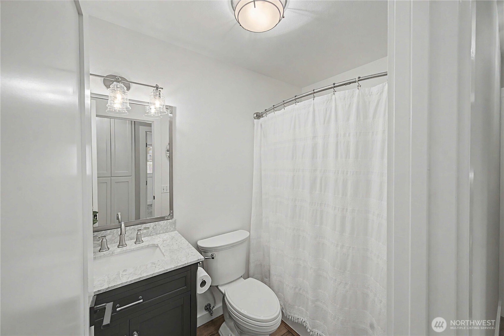 20919 Ronning Road Arlington, WA 98223 - Photo 15 of 28 a bathroom with a granite countertop sink toilet and mirror
