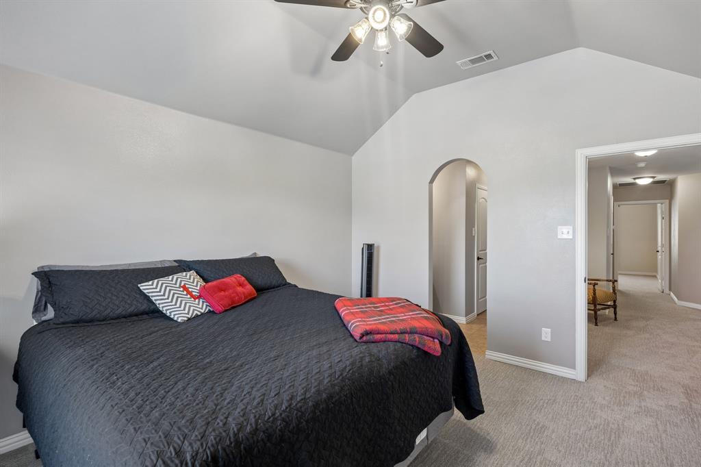 8104 Red Riv Run North Richland Hills, TX 76180 - Photo 22 of 38 a bedroom with a bed and a chandelier