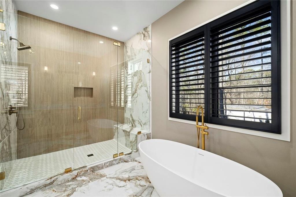 2309 Dinsmore Road Milton, GA 30004 - Photo 28 of 87 a bathroom with a bathtub and a shower