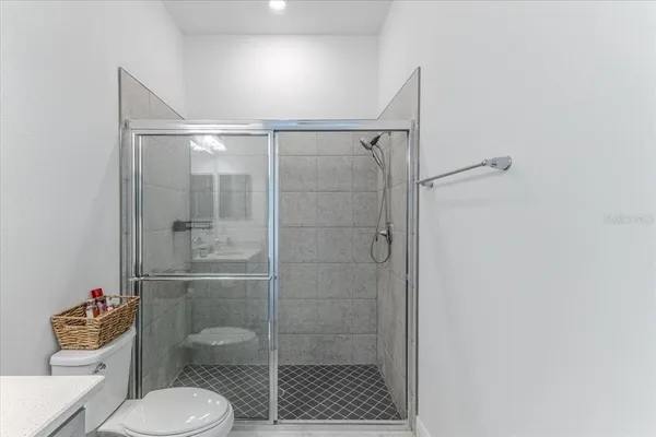 a bathroom with a toilet and a shower