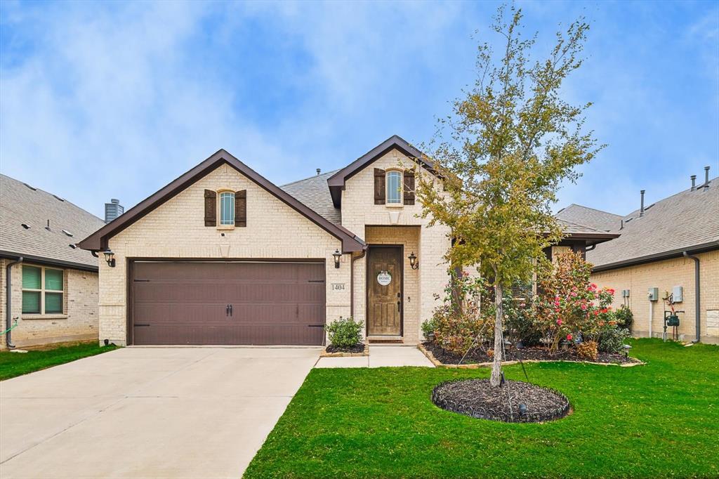 1404 Carancho Drive Little Elm, TX 75068 - Photo 1 of 1 a front view of a house with a garden