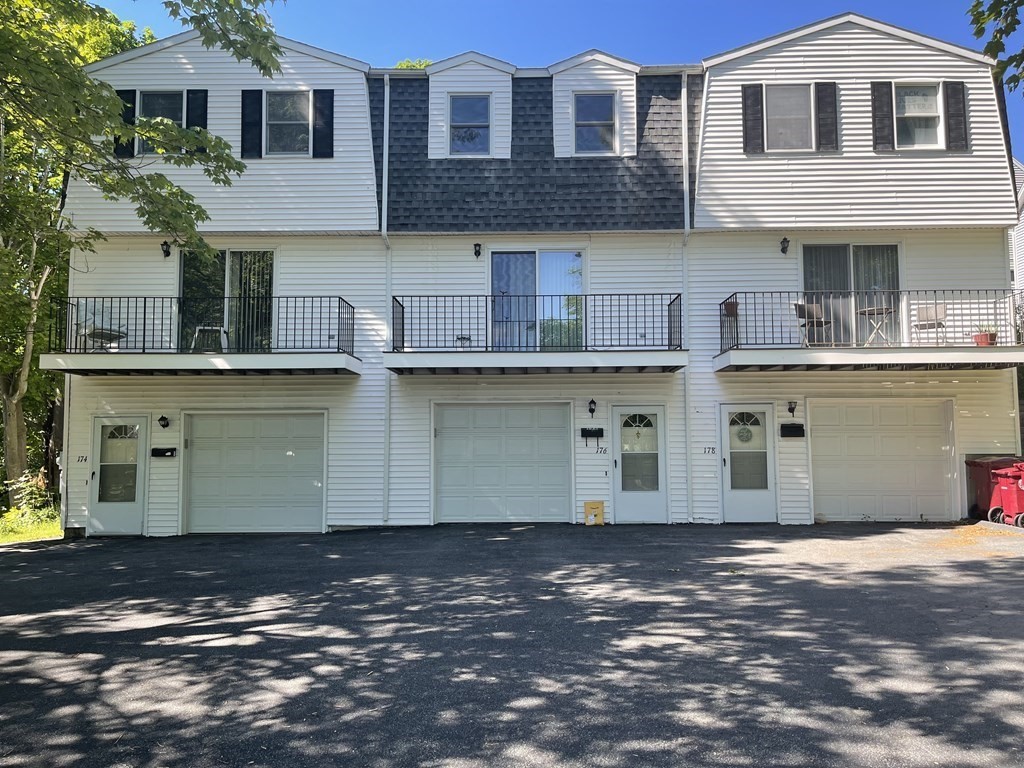 178 3rd Street, Unit 178 Lowell, MA 01850 - Photo 1 of 18 a front view of a house with a yard