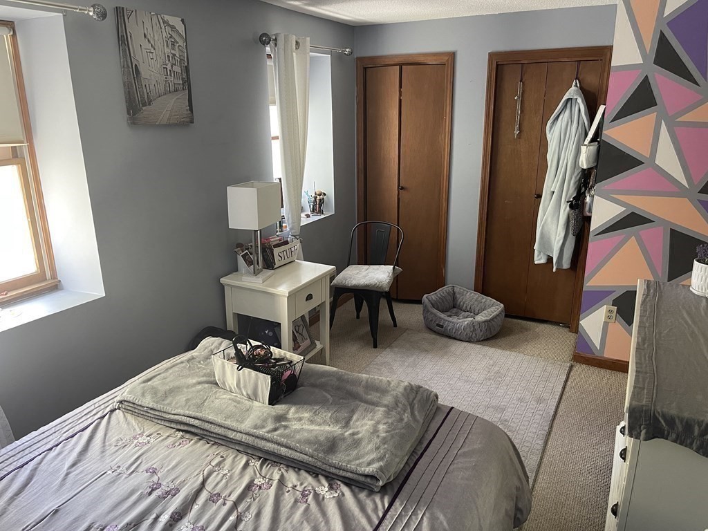 178 3rd Street, Unit 178 Lowell, MA 01850 - Photo 12 of 18 a view of a livingroom with furniture and a window