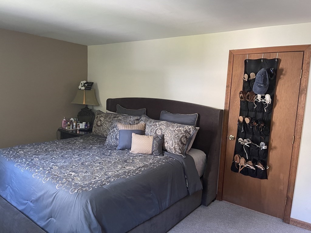 178 3rd Street, Unit 178 Lowell, MA 01850 - Photo 14 of 18 a bed sitting in a bedroom next to a window