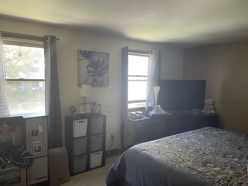 178 3rd Street, Unit 178 Lowell, MA 01850 - Photo 15 of 18 a bedroom with a bed and a window