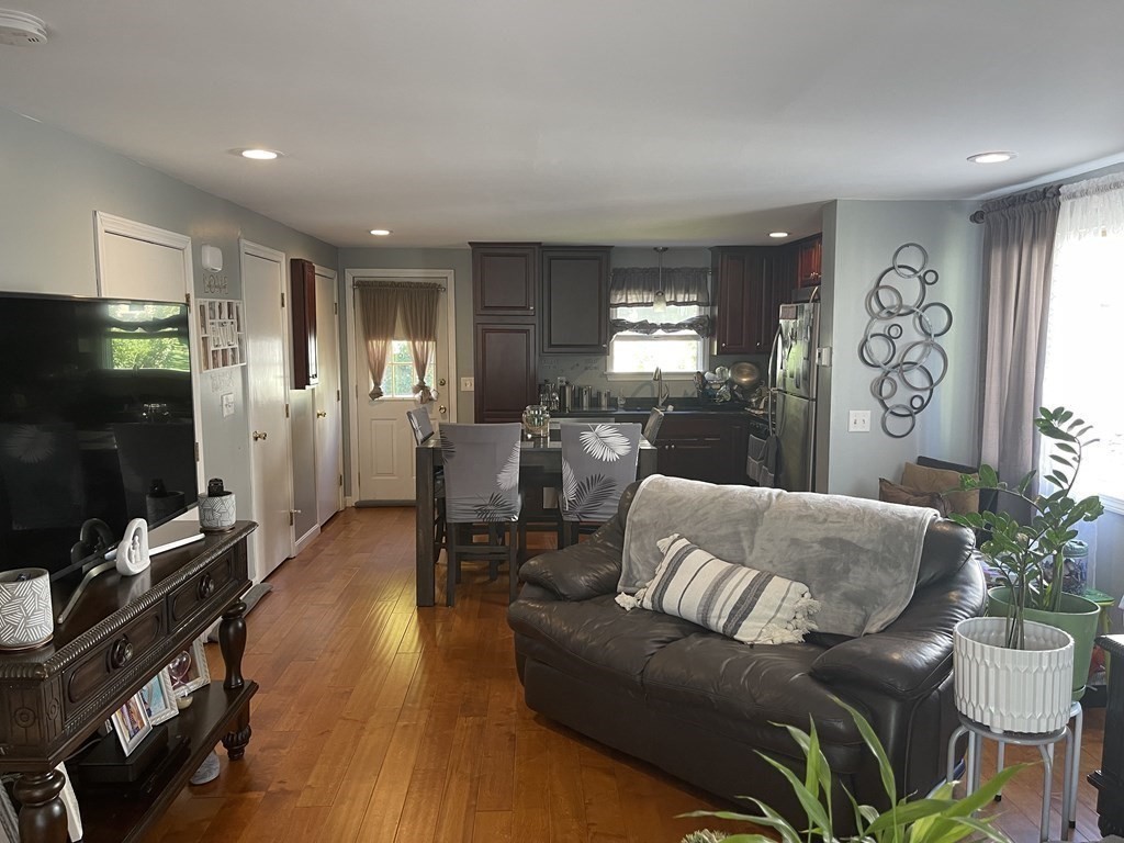 178 3rd Street, Unit 178 Lowell, MA 01850 - Photo 5 of 18 a living room with furniture and a flat screen tv