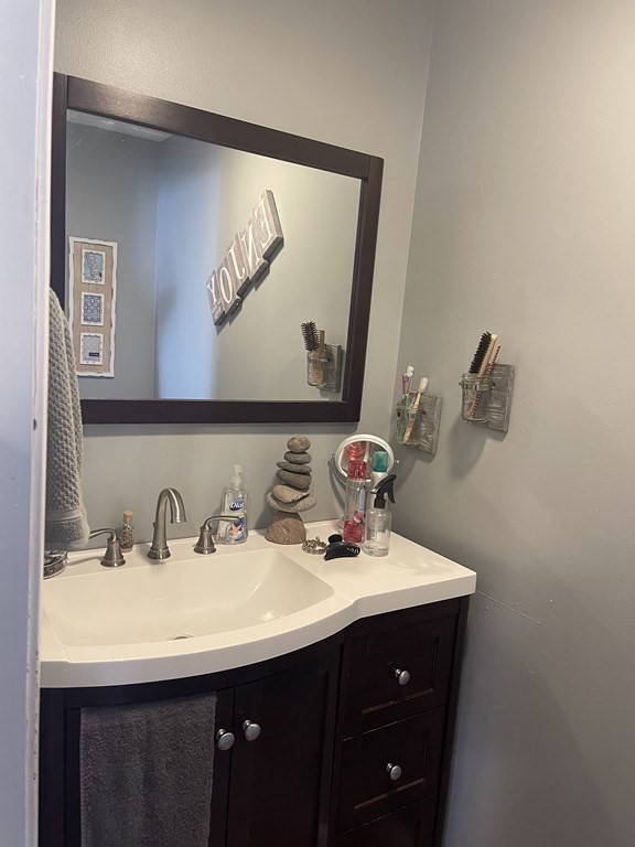 178 3rd Street, Unit 178 Lowell, MA 01850 - Photo 7 of 18 a bathroom with a sink and a mirror