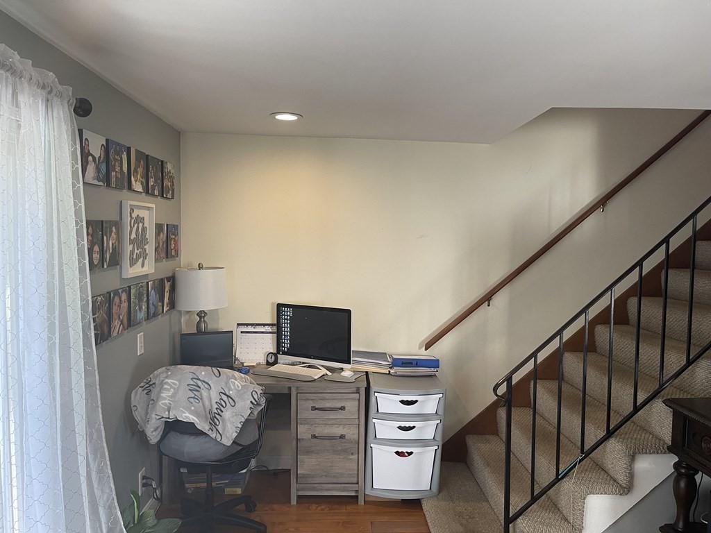 178 3rd Street, Unit 178 Lowell, MA 01850 - Photo 8 of 18 a bedroom with furniture and a flat screen tv