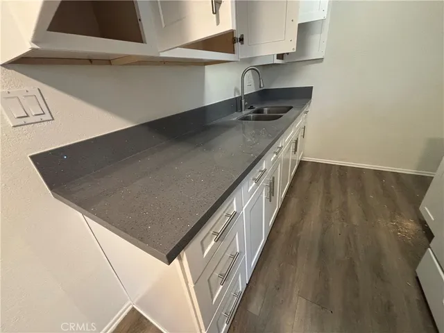 a kitchen with a sink a stove and cabinets