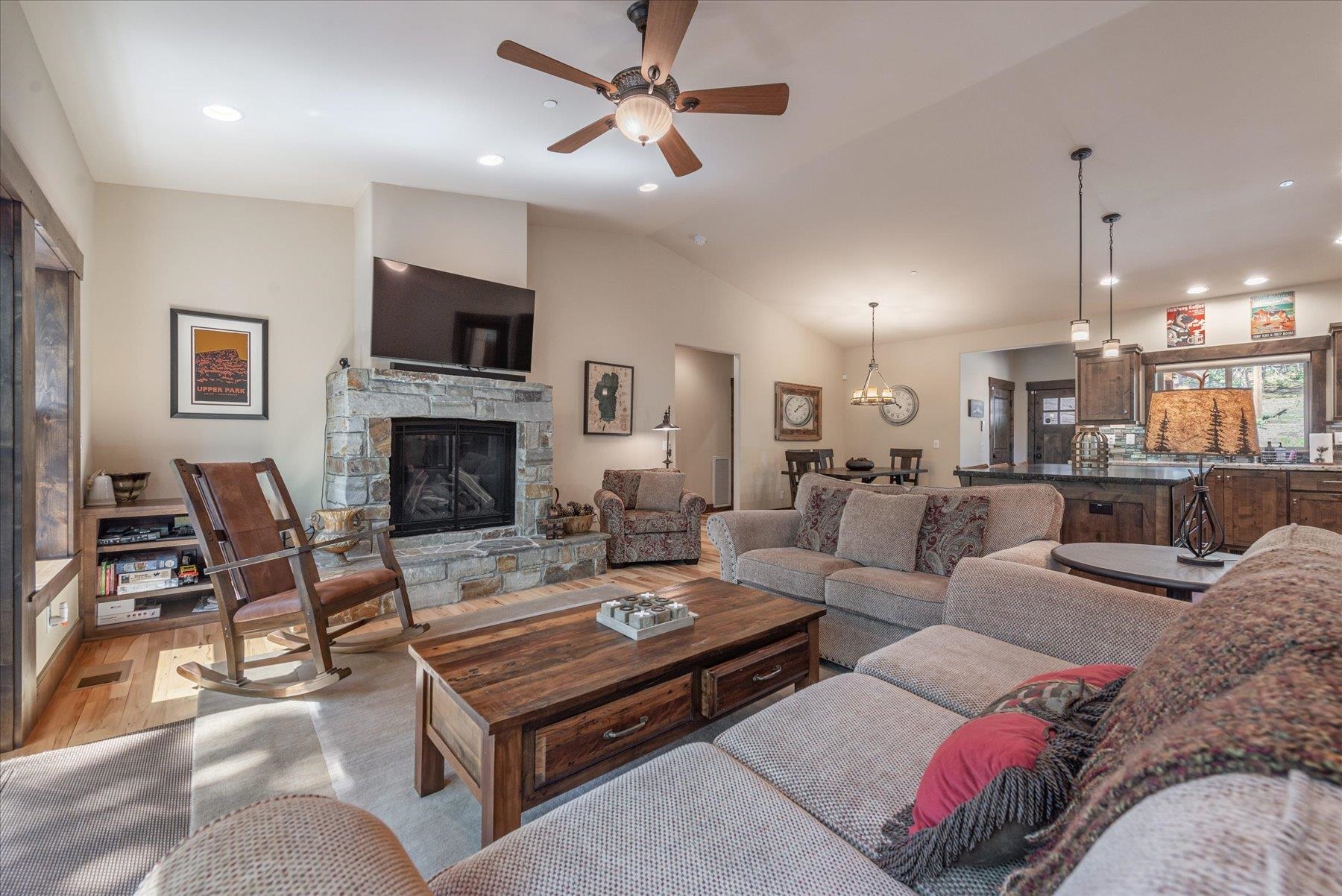 14475 Alder Creek Road Truckee, CA 96161 - Photo 12 of 21 a living room with furniture a flat screen tv and a fireplace
