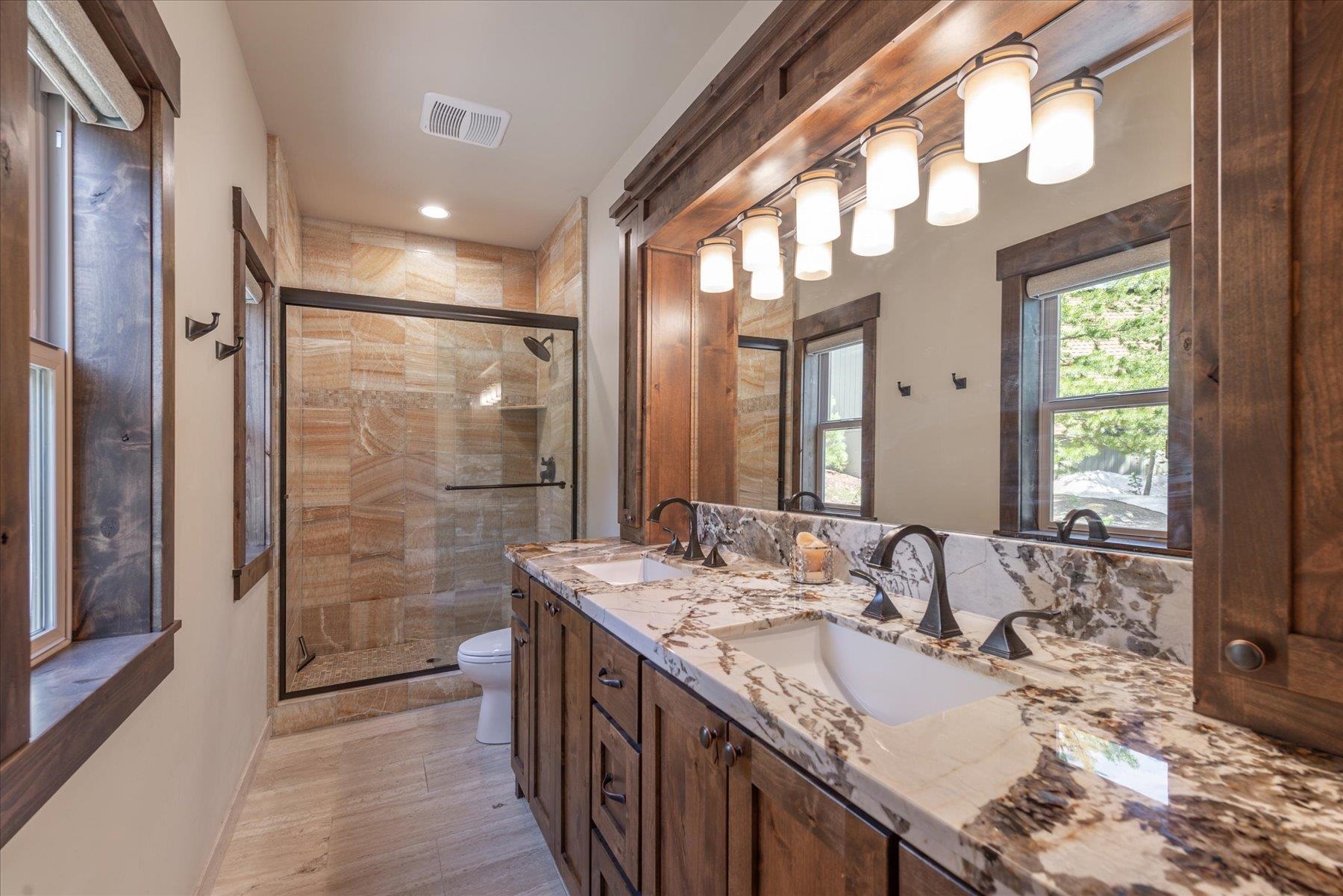 14475 Alder Creek Road Truckee, CA 96161 - Photo 14 of 21 a bathroom with double vanity sinks and a shower