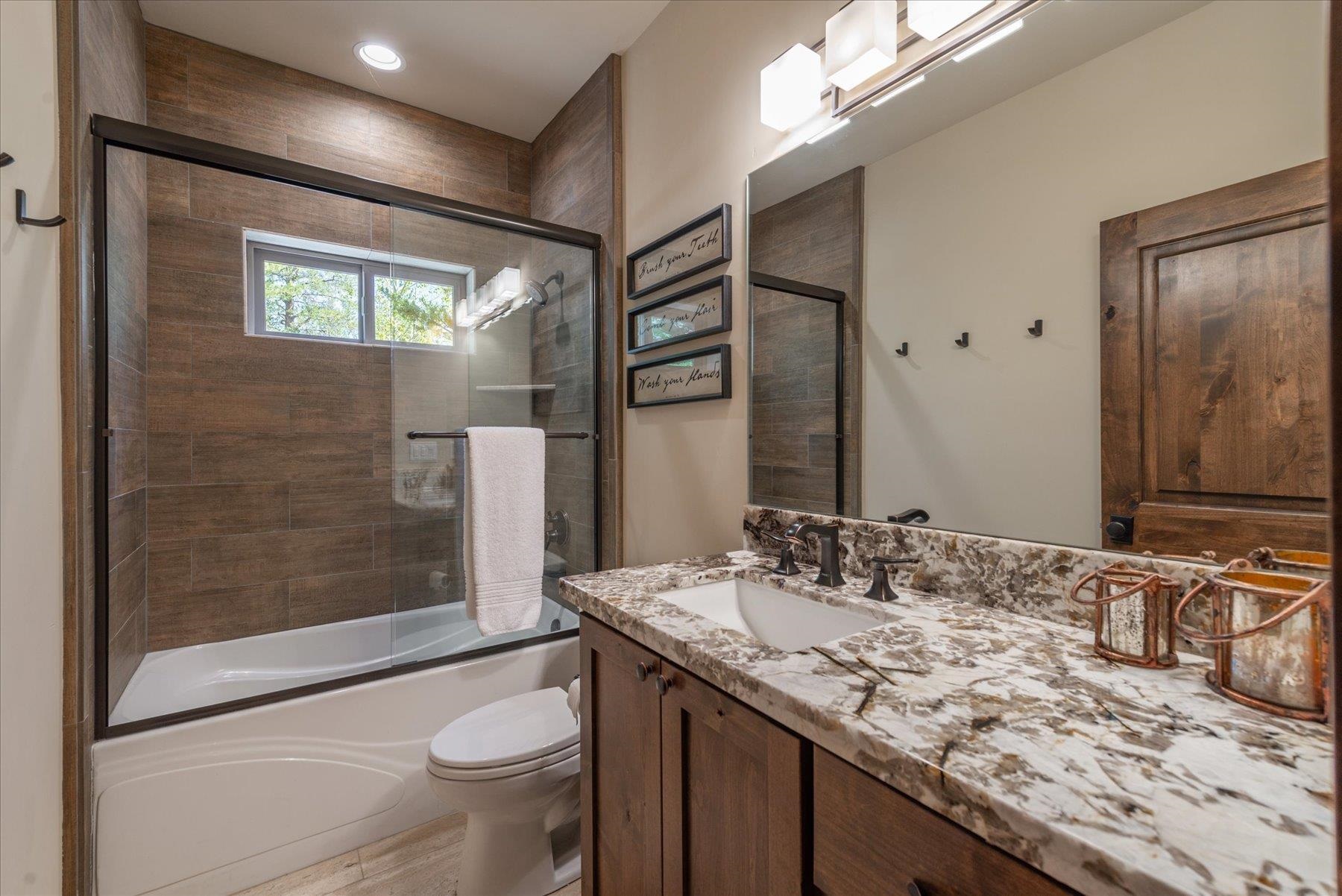 14475 Alder Creek Road Truckee, CA 96161 - Photo 17 of 21 a bathroom with a granite countertop sink toilet and shower