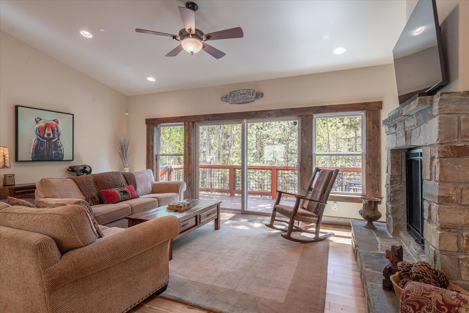 14475 Alder Creek Road Truckee, CA 96161 - Photo 10 of 21 a living room with furniture a fireplace and a floor to ceiling window
