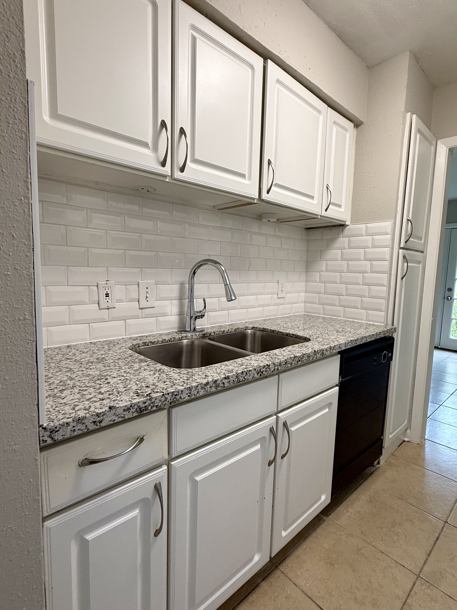1518 Wirt Road, Unit 6 Houston, TX 77055 - Photo 5 of 14 a kitchen with white cabinets and a sink