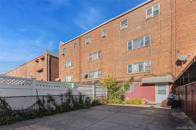 a front view of a building with plants