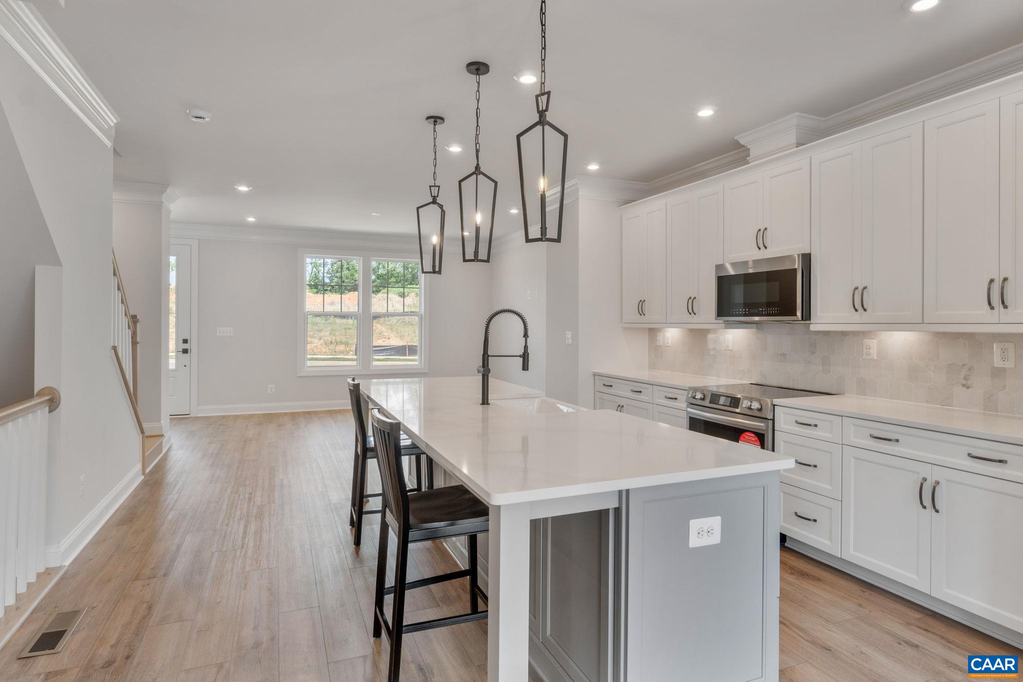 797 Park Ridge Drive Crozet, VA 22932 - Photo 17 of 43 a kitchen with stainless steel appliances granite countertop a sink a stove and a wooden floors