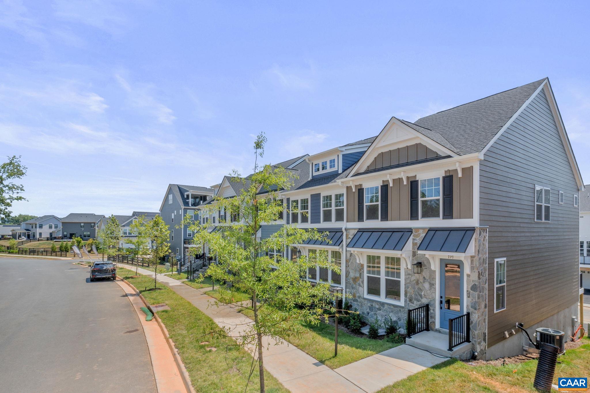 797 Park Ridge Drive Crozet, VA 22932 - Photo 2 of 43 a front view of a house with a garden and lake view