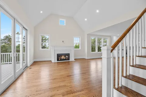 a view of backyard with swimming pool and seating space