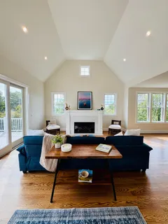 a view of hallway with a floor to ceiling window and wooden floor