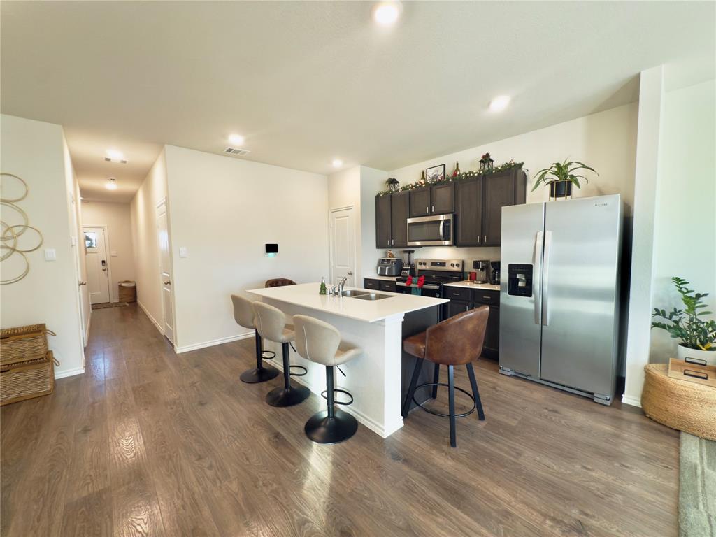 6000 Holly Spg Road Princeton, TX 75407 - Photo 13 of 27 a kitchen with a sink appliances and cabinets