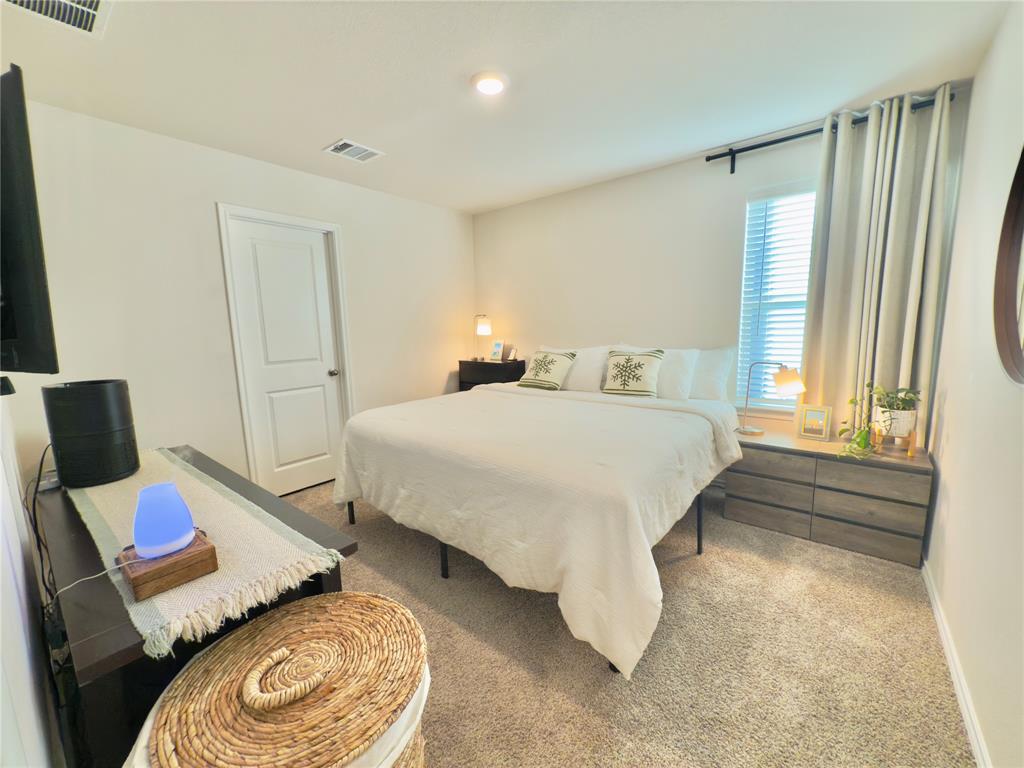 6000 Holly Spg Road Princeton, TX 75407 - Photo 17 of 27 a bedroom with a bed and wooden floor