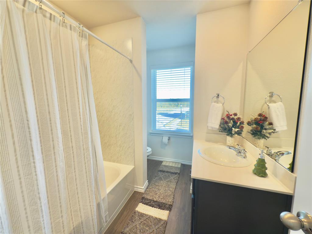 6000 Holly Spg Road Princeton, TX 75407 - Photo 18 of 27 a bathroom with a sink and a mirror