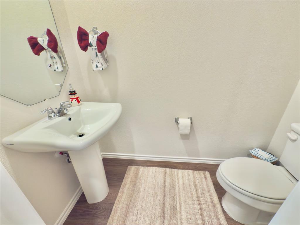 6000 Holly Spg Road Princeton, TX 75407 - Photo 26 of 27 a bathroom with a sink mirror and toilet