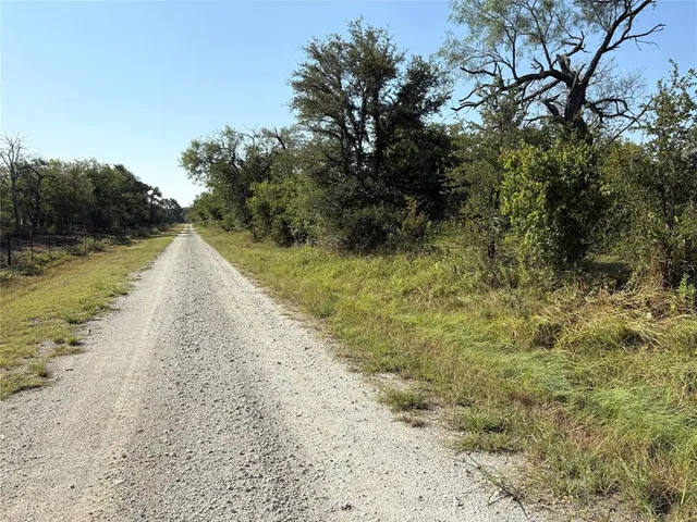 a view of a lake with beach and trees
