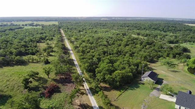 an aerial view of a houses with a yard