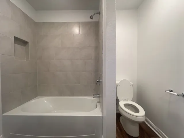 a white bath tub sitting next to a white toilet