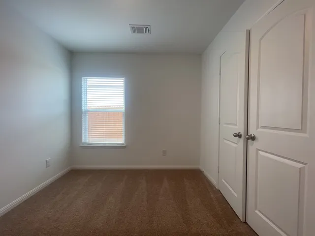 an empty room with a empty space and window