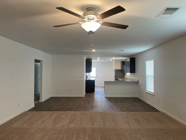 a view of kitchen with center island and stainless steel appliances